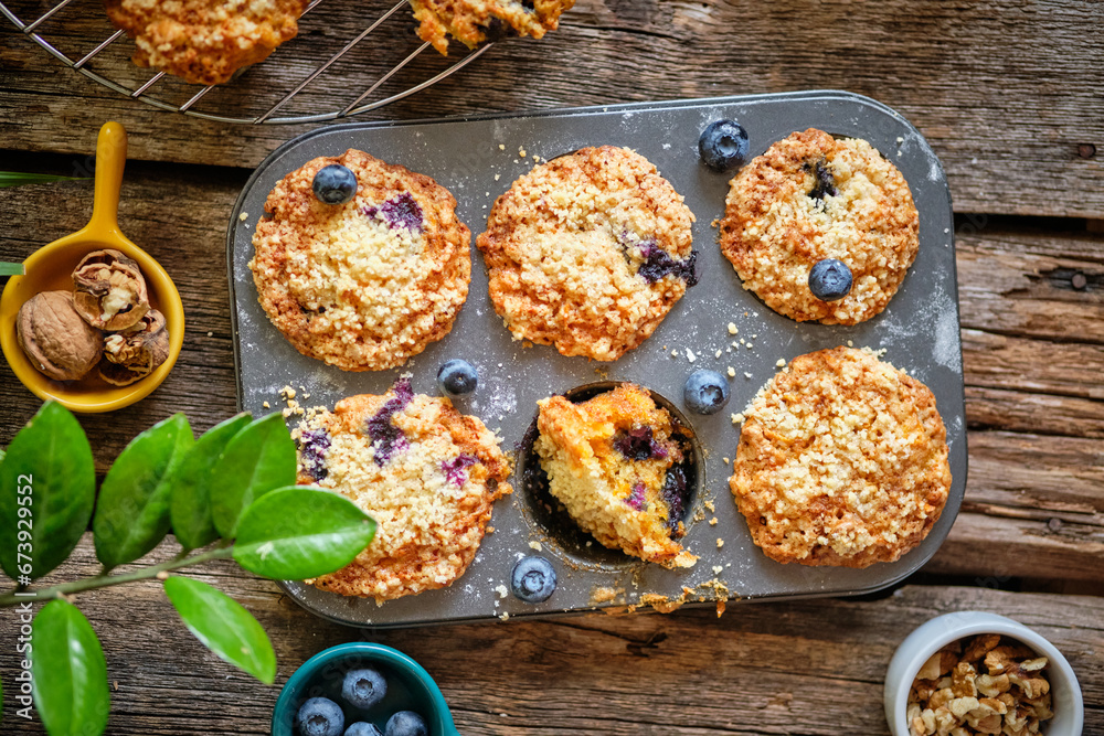 Carrot muffin with blueberries and walnuts. Wooden background. Top view. Carrot muffin with blueberries and walnuts. Wooden background. Top view.