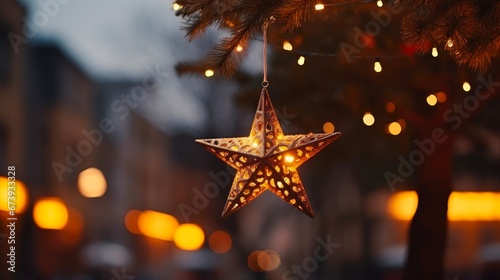 Christmas Decor Exterior: Stylish Merry Christmas Star Illumination and Festive Lights on Fir Branches. Atmospheric Winter Holidays in Europe.