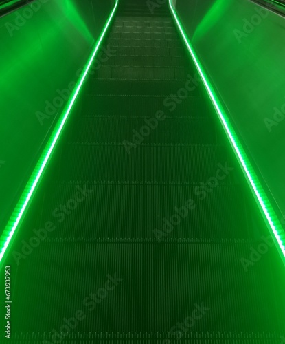 Escalator with a modern design featuring a glowing LED light photo