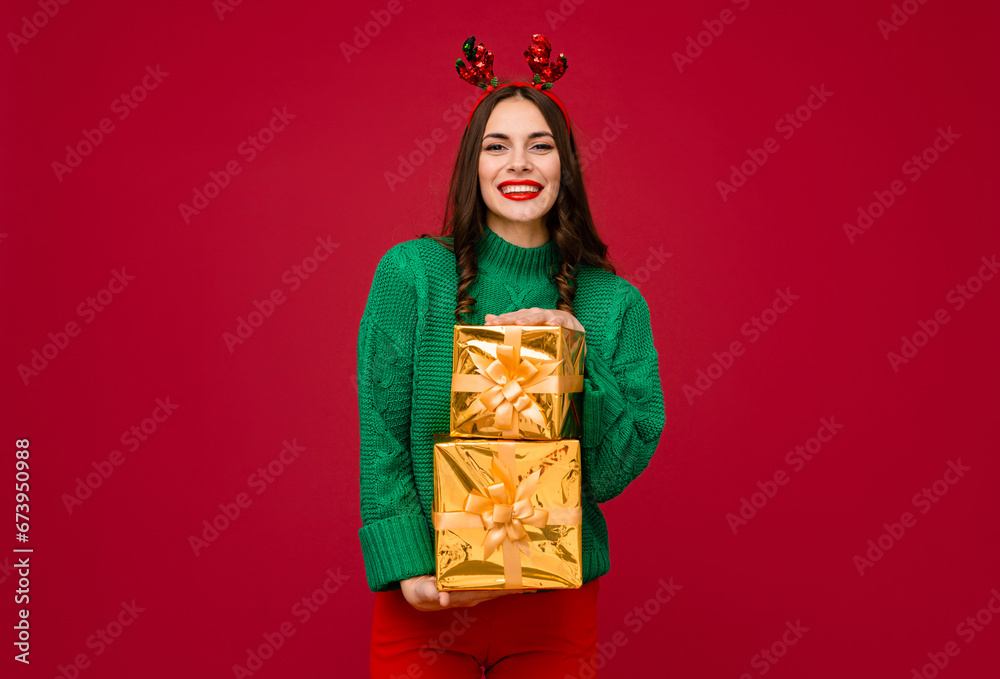 attractive woman celebrating Christmas on red background
