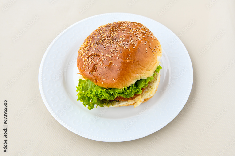 Big tasty burger with beef cutlet on a plate. Hamburger. Crispy chicken burger. Big tasty burger with beef cutlet on a plate. Hamburger. Crispy chicken burger.
