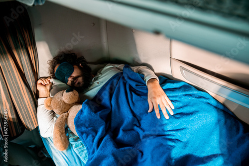 Young man sleeping in truck cabin photo