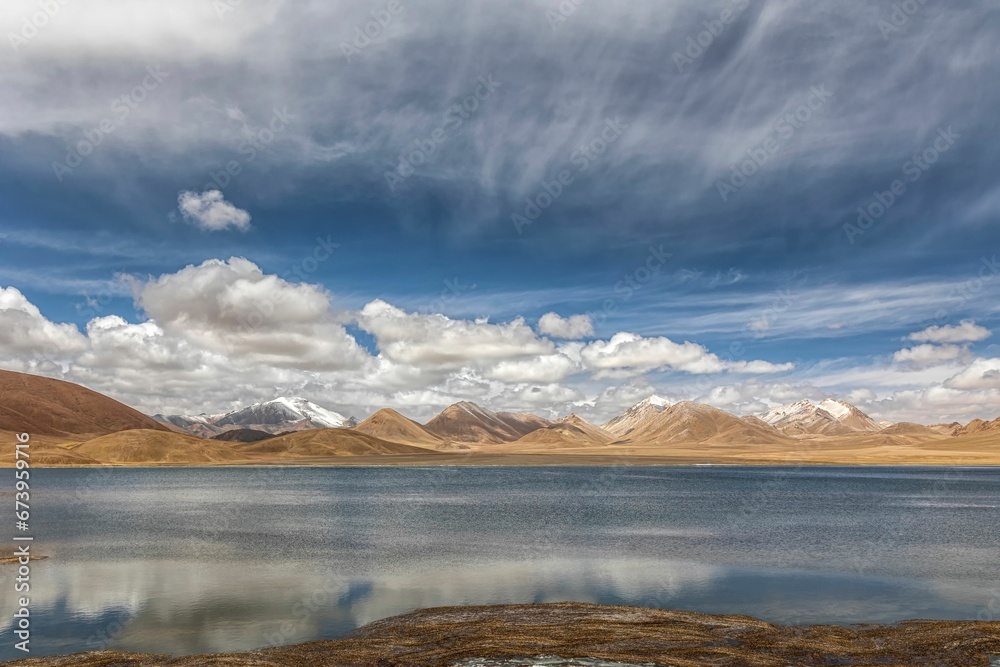 Stunning landscape in the Ali region of Tibet, with majestic mountains and a tranquil blue lake
