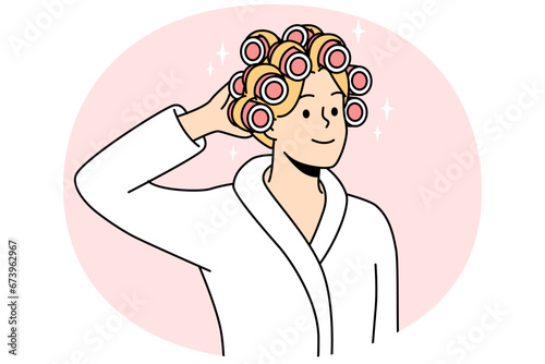 Smiling young woman in bathrobe and curlers on head getting ready. Happy female do beauty procedures at home. Vector illustration.