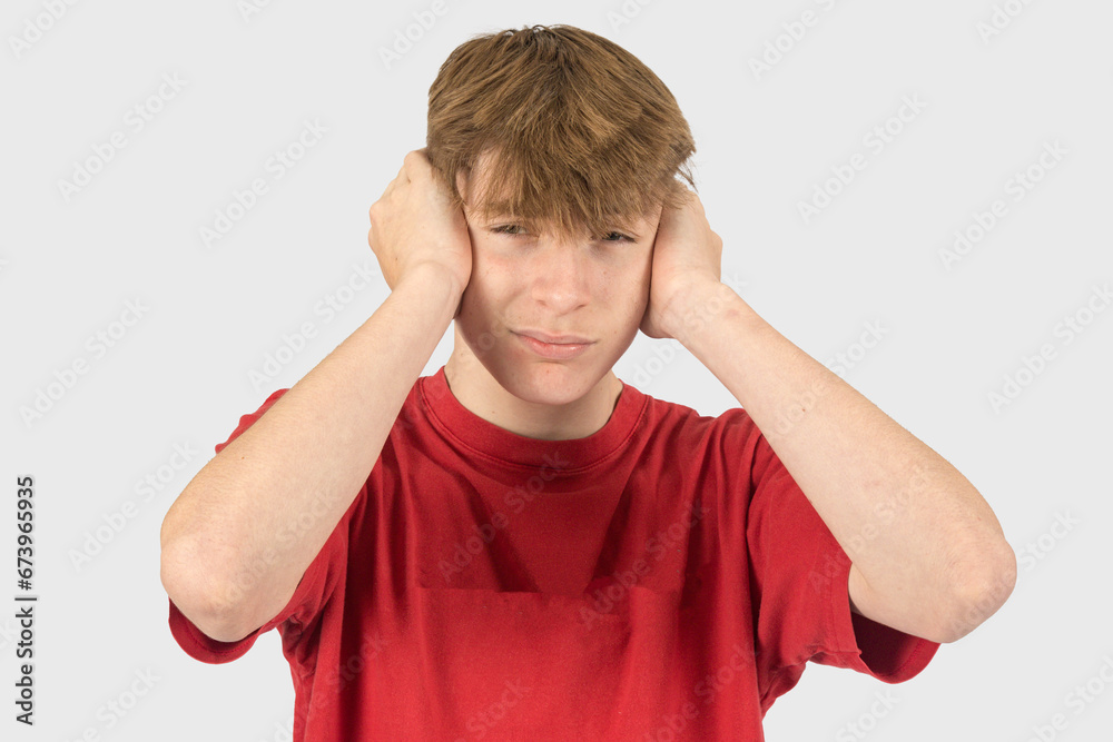 Fototapeta premium Headshot of a teenage boy covering his ears
