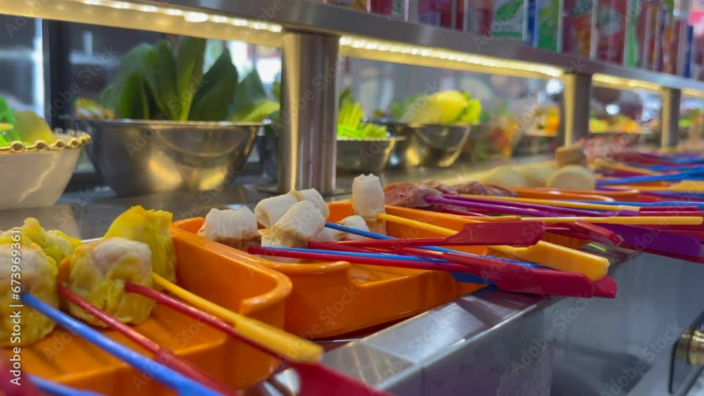 conveyor belt restaurant that allows customers to select food ingredients and put them in a boiling pot with soup. conveyor belt restaurant that allows customers to select food ingredients and put them in a boiling pot with soup.