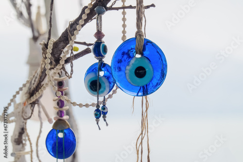 Traditional Turkish amulet Evil Eye or blue eye (Nazar boncugu). Souvenir of Turkey and traditional turkish amulet on tree branch