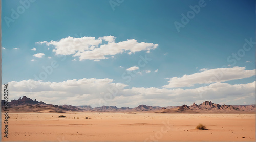 Suny desert panoramic view of sand dunes and mountains with blue sky and white clouds