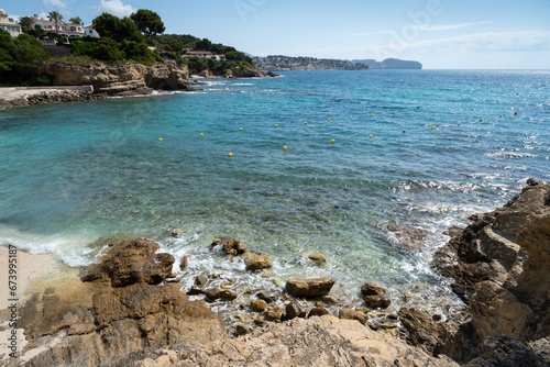 rocky beach and blue sea water on the Mediterranean coast scenic seascape for travel and holidays