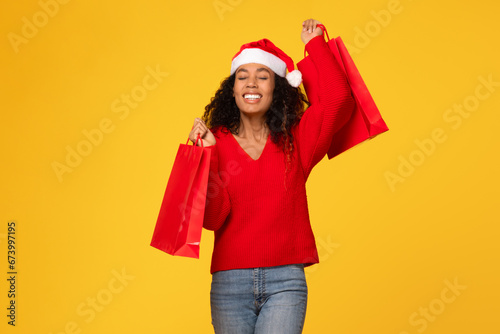 Christmas shopping done, black woman with red bags, festive mood