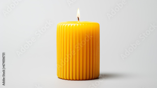 A yellow candle isolated on white background photo