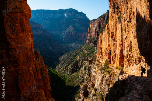 Hiker Passing The Eye of the Needle on the North Kaibab Trail in Roaring Springs Canyon, Grand Canyon National Park, Arizona, USA