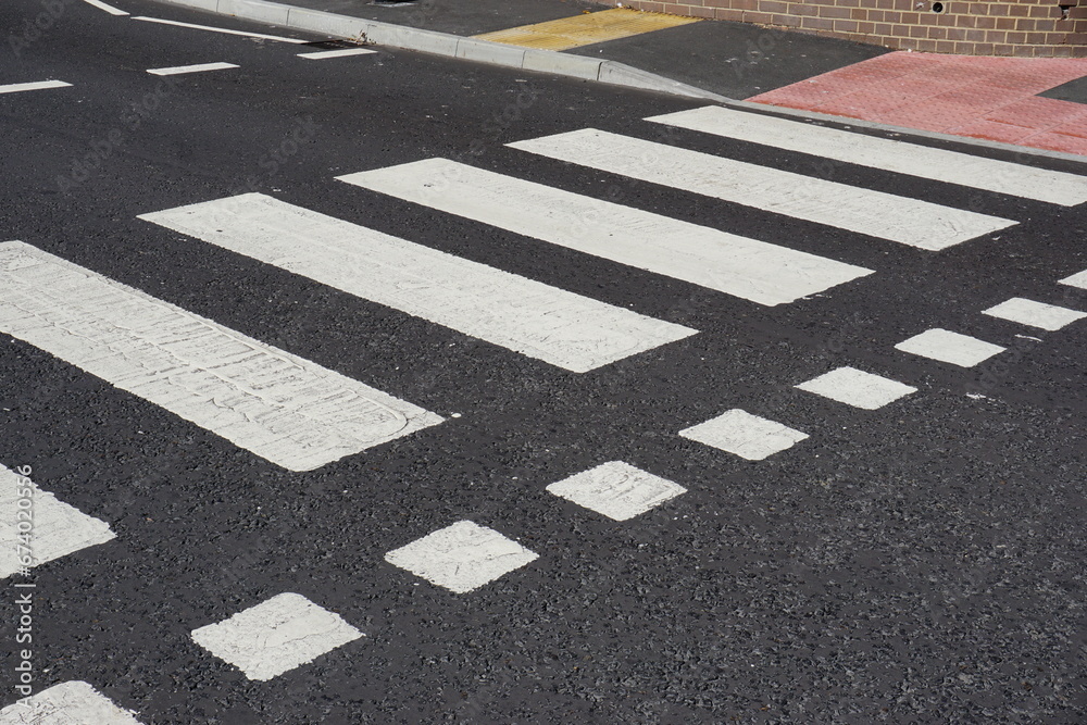 zebra crossing point on UK road. painted road crossing markings. pedestrian safety  - obrazy, fototapety, plakaty 