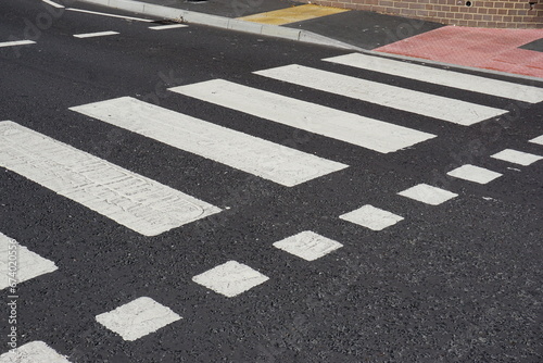 zebra crossing point on UK road. painted road crossing markings. pedestrian safety  photo