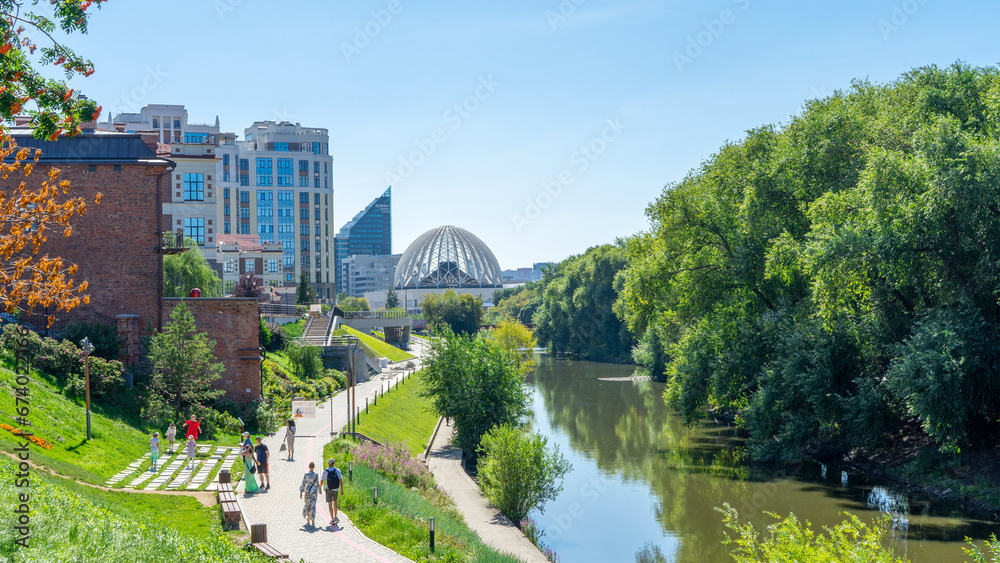 Embankment of Iset River, Yekaterinburg, Russia. Luxury residential complex Riviera. Circus building. City promenade. Walking in city center