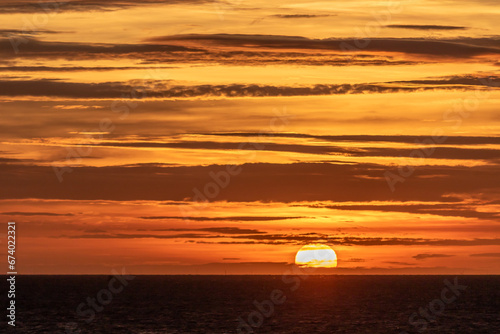 sunrise on the sea, Image shows the sun rising over Dovercourt beach in the early hours of the morning giving a beautiful golden glow, taken october 2023