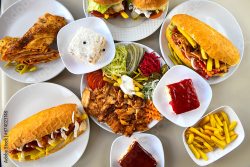 Turkish and Arabic Traditional Ramadan doner kebab with tasty tomato sauce and rice or turkish pilav in white plate on wood table background. ( Pilav ustu et doner, Hatay tavuk doner iskender kebap ) photo