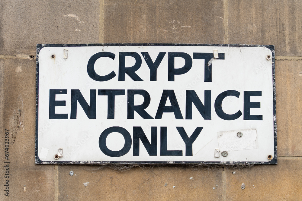 A sign reads, Crypt Entrance Only. Halloween concept. A sign reads, Crypt Entrance Only. Halloween concept.