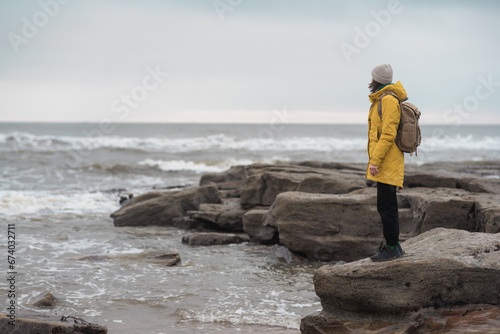 Beautiful woman traveler enjoying autumn hiking at the seaside. Active lifestyle