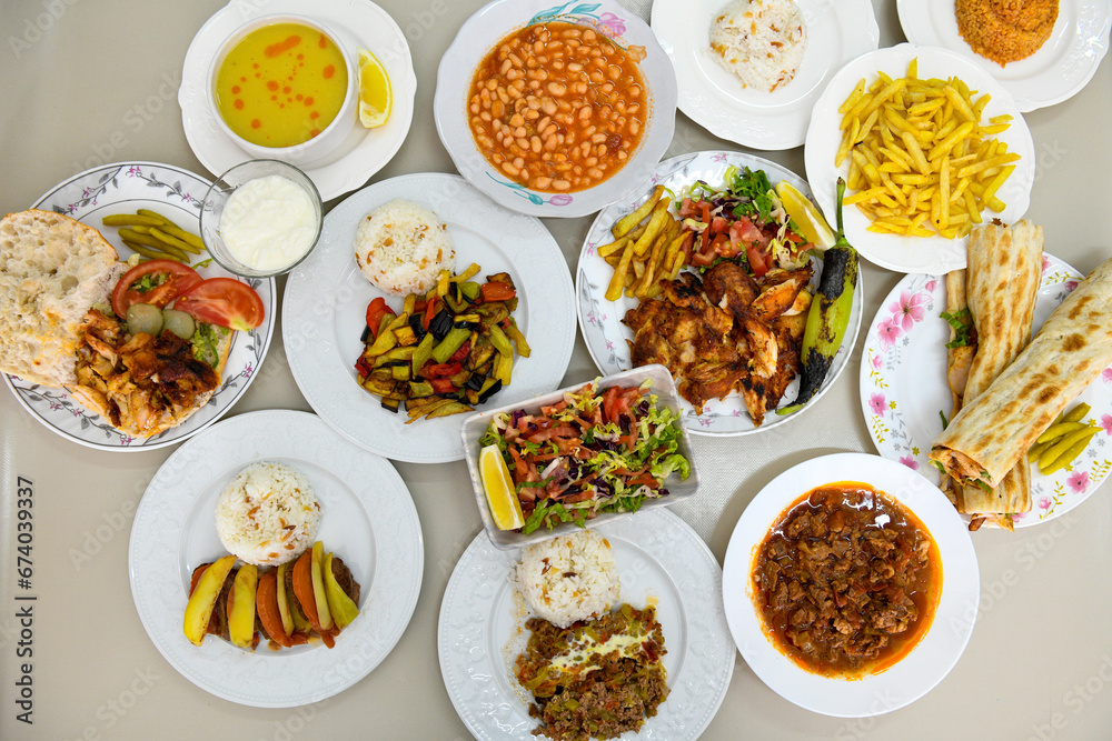 Table scene of assorted take out or delivery foods. Traditional Turkish cuisine. Various Turkish meal and appetizers. Top down view on a table. Table scene of assorted take out or delivery foods. Traditional Turkish cuisine. Various Turkish meal and appetizers. Top down view on a table.