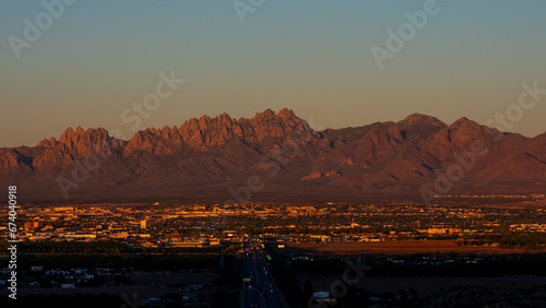 a sunset over Las Cruces, New Mexico with a the organ mountains in the background