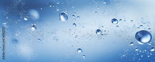 Water drops or oil bubbles on blue background. panorama picture.