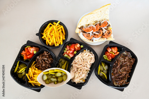 Turkish and Arabic Traditional Ramadan doner kebab with tasty tomato sauce and rice or turkish pilav in white plate on wood table background. ( Pilav ustu et doner, Hatay tavuk doner iskender kebap ) photo