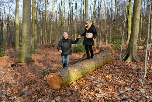 Active senior couple in autumn forest