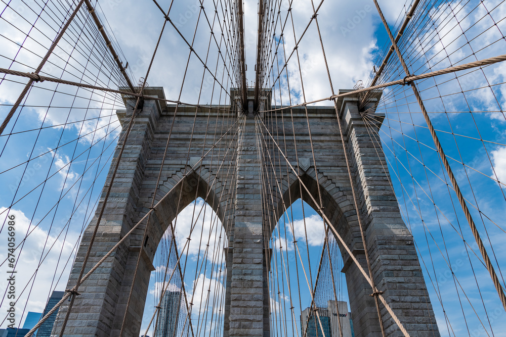 Fototapeta premium way to manhattan. brooklyn bridge in new york. amazing scenery of brooklyn bridge in metropolis. architecture of historic bridge in brooklyn. american architecture landmark. crossing hudson river