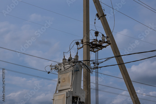 Power line poles and wires with a transformer. Distribution panel.