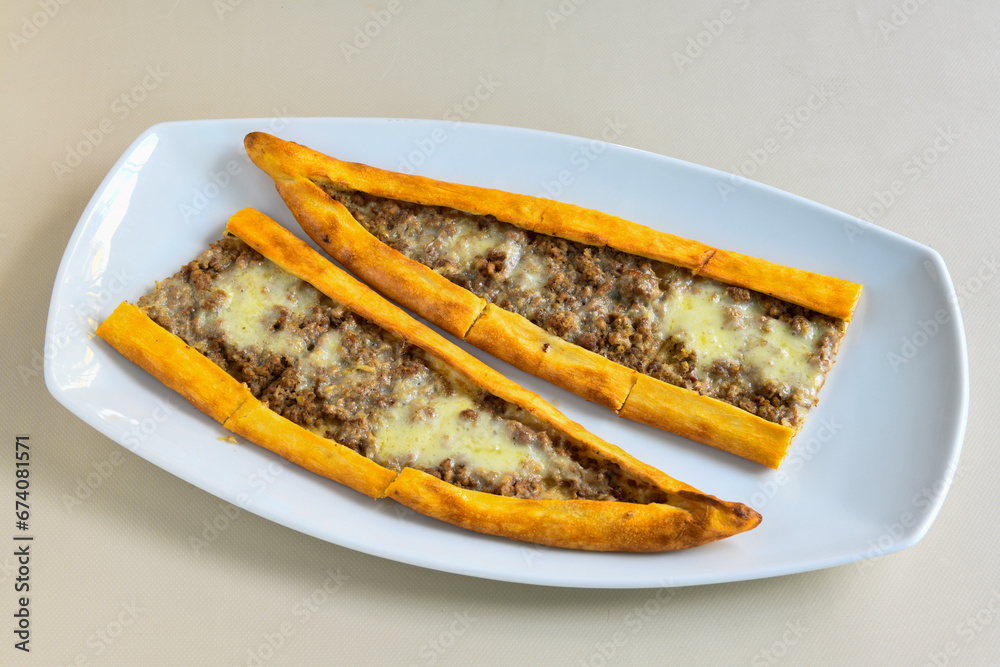 Kiymali pide.Turkish pide with minced meat. Turkish pizza mince pita Pide on white background. Etli ekmek. Kusbasi kasarli, kiymali kasarli, kiymali yumurtali, tirnak Trabzon, Bafra, Kusbasili pide. Kiymali pide.Turkish pide with minced meat. Turkish pizza mince pita Pide on white background. Etli ekmek. Kusbasi kasarli, kiymali kasarli, kiymali yumurtali, tirnak Trabzon, Bafra, Kusbasili pide.