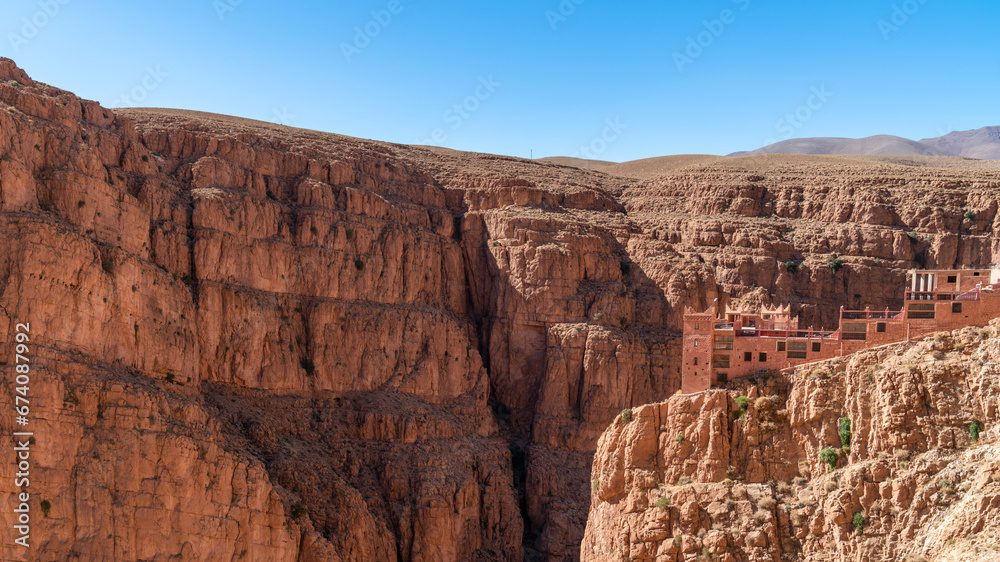 Hotel at the top of Dades Gorges, a series of canyons formed by the Dades River. Red and orange rock formations create a dramatic and picturesque landscape.