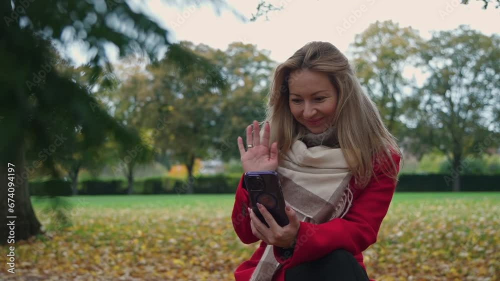 The woman communicates through her phone via video link The woman communicates through her phone via video link