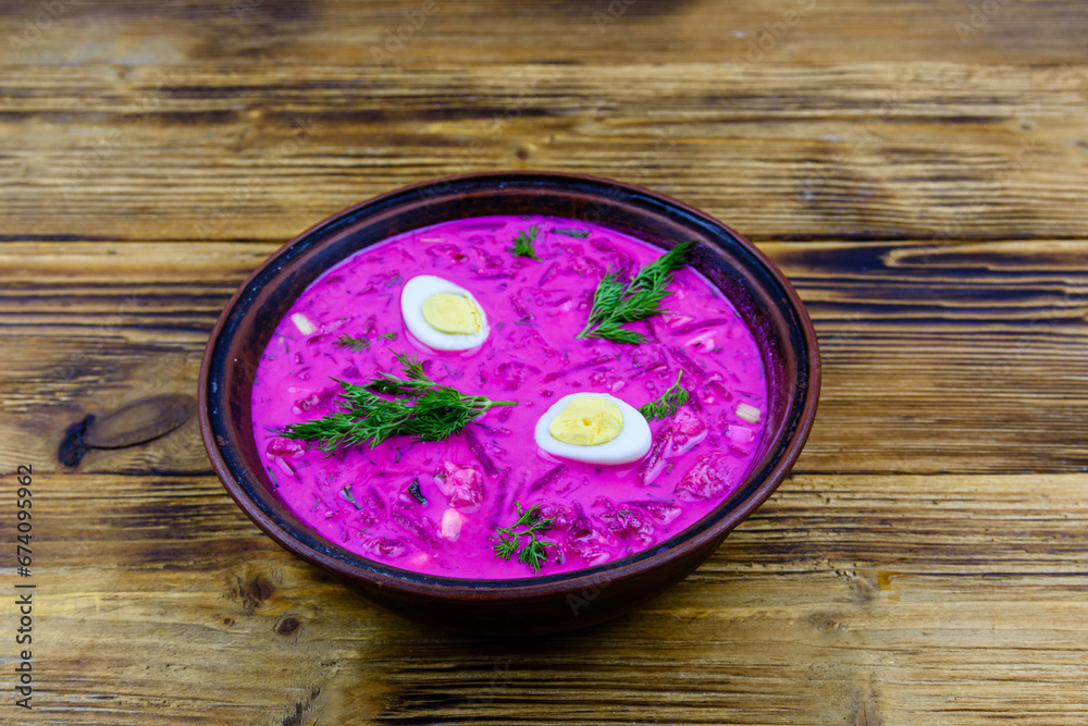 Plate with beet soup on a wooden table Plate with beet soup on a wooden table