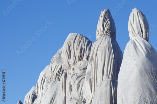 Few trees covered by an awning against the blue sky.