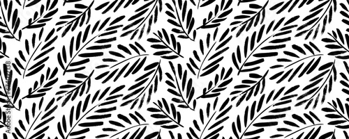 Palm leaves and branches seamless pattern. Brush drawn tropical wallpaper.