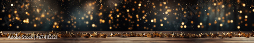Horizontal holiday card with golden glowing stars on a wooden surface. Can be used as a banner, gift card for Happy New Year, Christmas, and other holidays. photo
