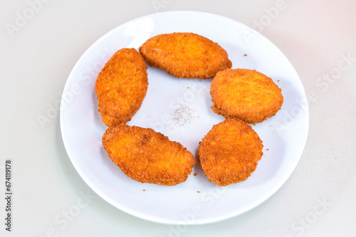 Fried Chicken breast hot crispy strips crunchy chicken tenders isolated on white background.Nuggets isolated on white background on a plate