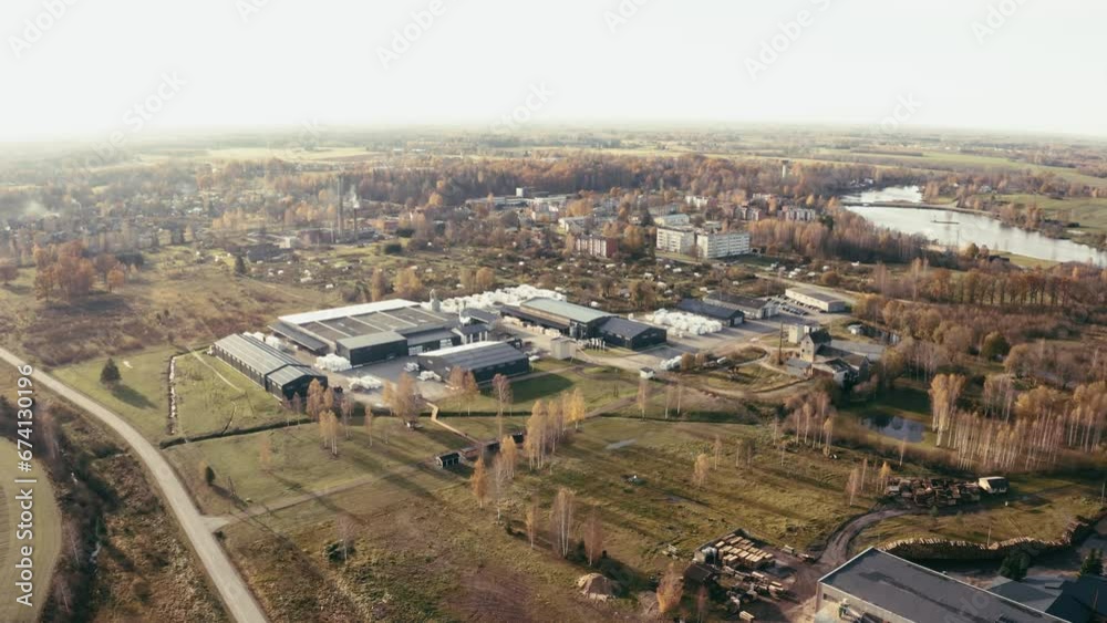 Aerial drone view of group of large modern industrial warehouse or factory buildings in suburban city area. Aerial drone view of group of large modern industrial warehouse or factory buildings in suburban city area.