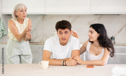 Elderly woman swears at young married couple. Complex intergenerational relationships