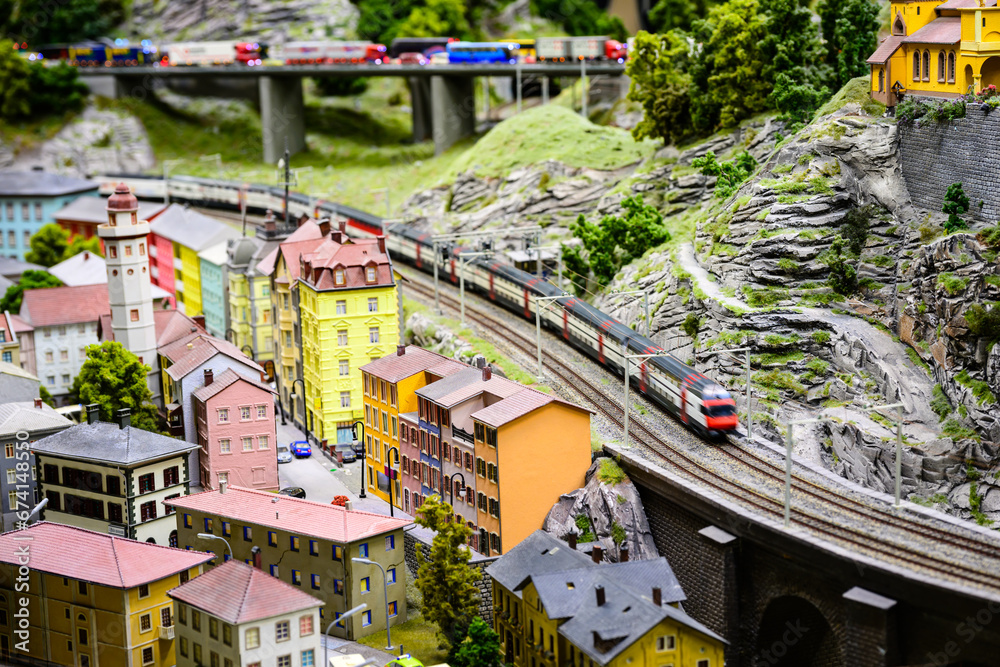 Fototapeta premium view of the train coming around the mountain in a model railway of alpine village