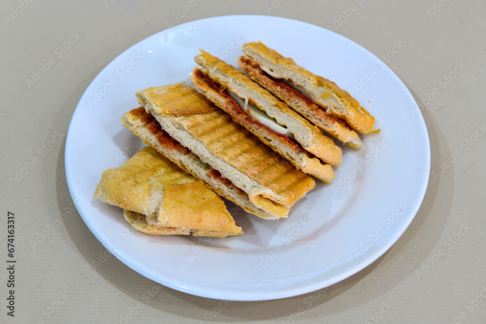 Turkish karisik atom tost ( kasarli bazlama tost) . Sucuklu, Kasarli, kavurmali karisik tost. Flat baked bread toasted Turkish karisik atom tost ( kasarli bazlama tost) . Sucuklu, Kasarli, kavurmali karisik tost. Flat baked bread toasted
