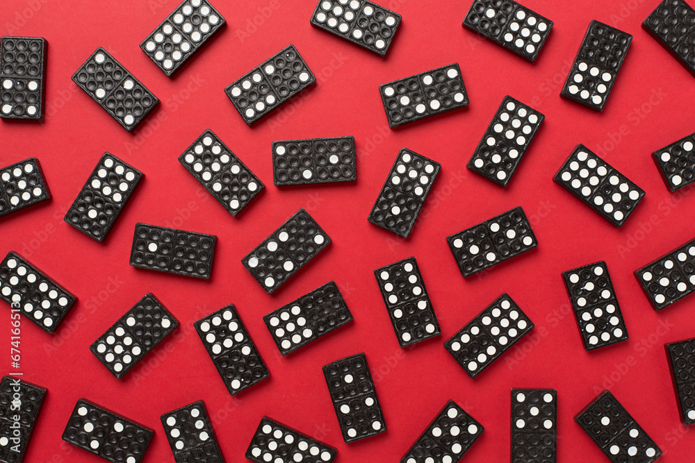 Black domino tiles on color background, top view