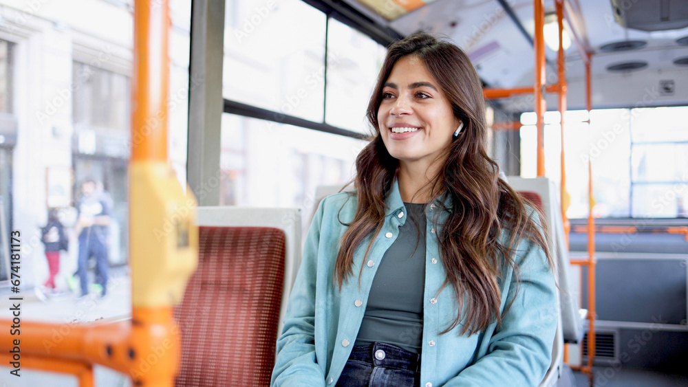 Happy young Latina woman in public transportation
