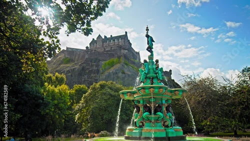 Panoramic view of Ross Fountain in Edinburgh, Scotland. Garden-side, cast-iron fountain representing science, arts, poetry and industry with Edinburgh Castle in the background.

 photo