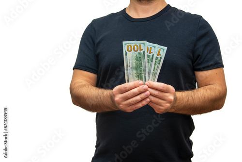 An unrecognizable person shows US dollars towards the camera with both hands