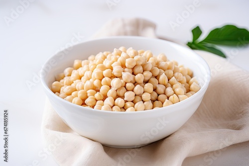 Spilled cooked chickpeas in a white bowl