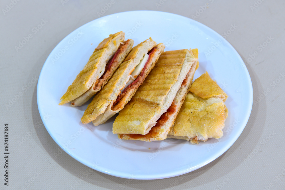Turkish karisik atom tost ( kasarli bazlama tost) . Sucuklu, Kasarli, kavurmali karisik tost. Flat baked bread toasted Turkish karisik atom tost ( kasarli bazlama tost) . Sucuklu, Kasarli, kavurmali karisik tost. Flat baked bread toasted