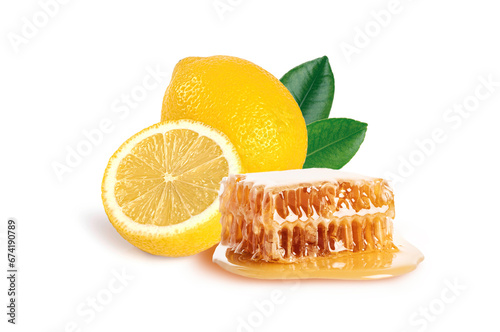 Honey comb with lemon and leaves isolated on white background.