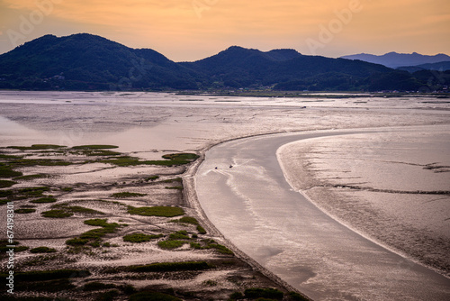 Sunset Suncheon Bay Nature Landscape at low tide in Suncheon City, Jeollanam-do, South Korea, a panoramic view of the curving river with cruising boats from the Yongsan Observatory